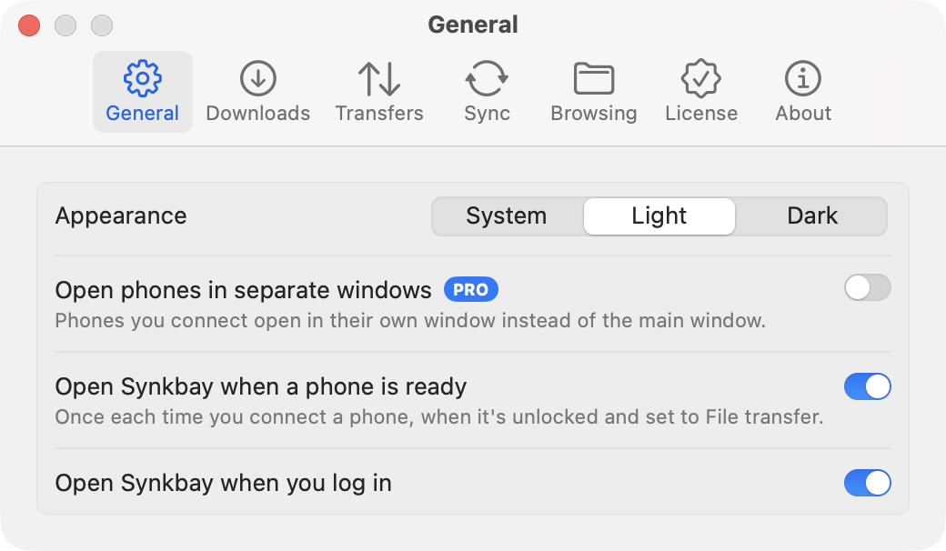 Settings, General tab: Appearance (System, Light or Dark), Open phones in separate windows (Pro), Open Synkbay when a phone is ready, and Open Synkbay when you log in
